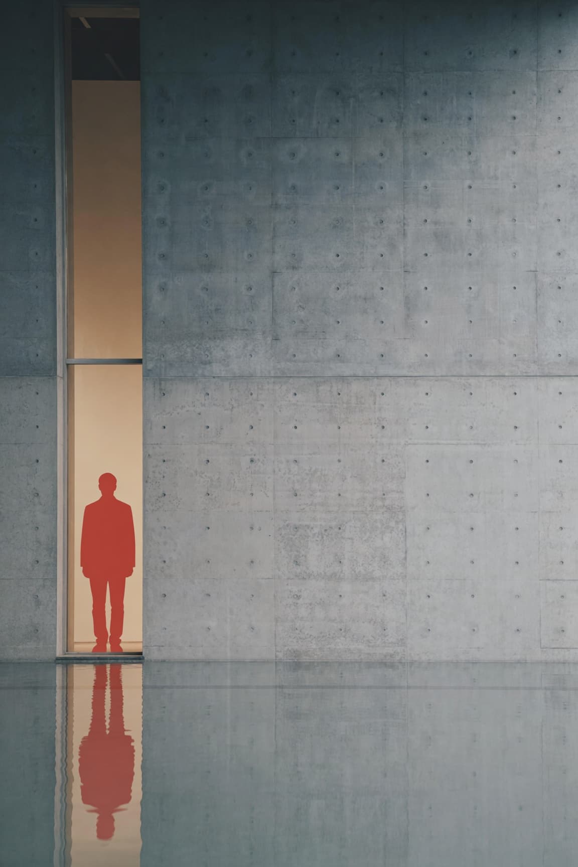 Concrete architectural facade with a vertical opening and a human silhouette in vintage red